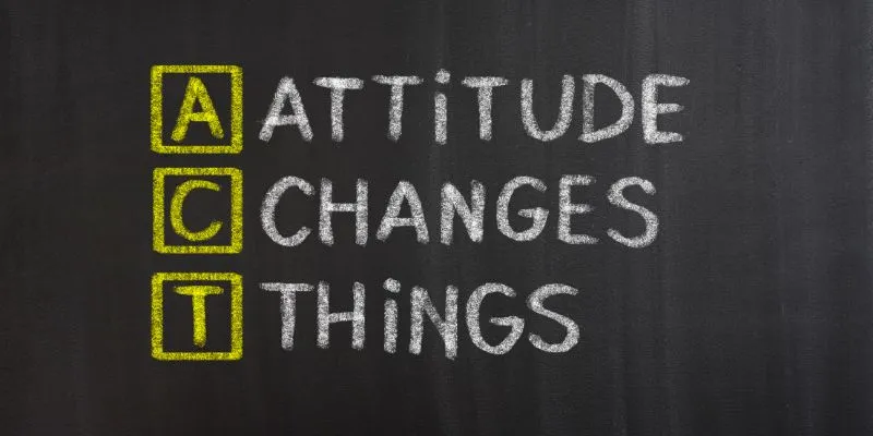A chalkboard displaying the message "attitude changes things" in bright chalk, emphasizes the power of a positive attitude
